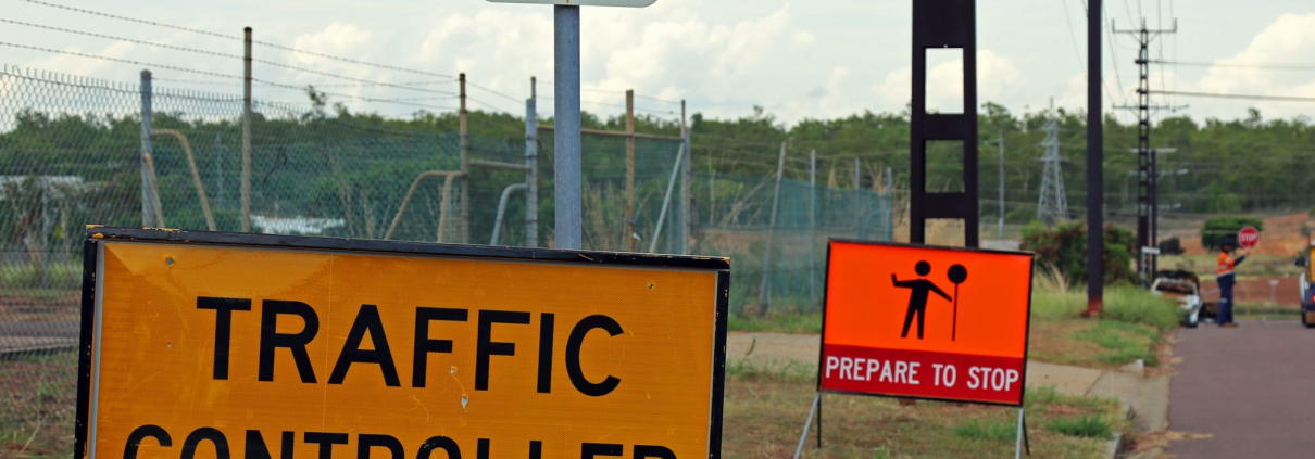 Traffic Controller in training yellow sign, at the start of work zone training