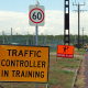 Traffic Controller in training yellow sign, at the start of work zone training