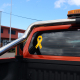 Yellow reflective ribbon is placed on the back of an orange work ute