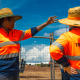 Sam Eveleigh is pictured on site with another Traffic Controller they are observing and pointing to something on the work site