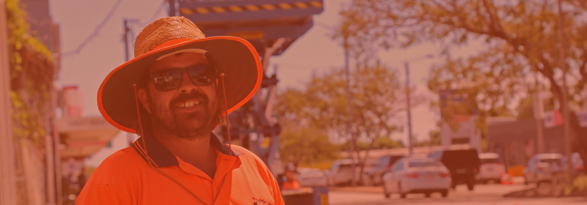 Nathan our Traffic Controller is stood in from of a work site, wearing PPE