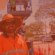 Nathan our Traffic Controller is stood in from of a work site, wearing PPE
