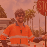 Traffic Controller Marco stand with a stop bat in front of a truck on a work site in Darwin.