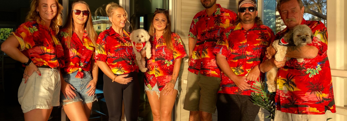 Trafficwerx NT Team members stood in a line wearing matching bright orange tropical shirts before the networking event.