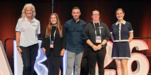 Nikita Bennett stands on stage at the START26 Conference alongside other Traffic Controller of the Year finalists.