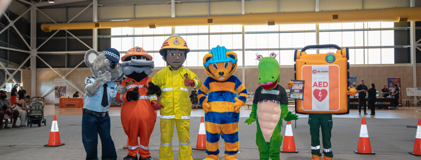 Safety mascots stand in a row at the Darwin Safety Expo